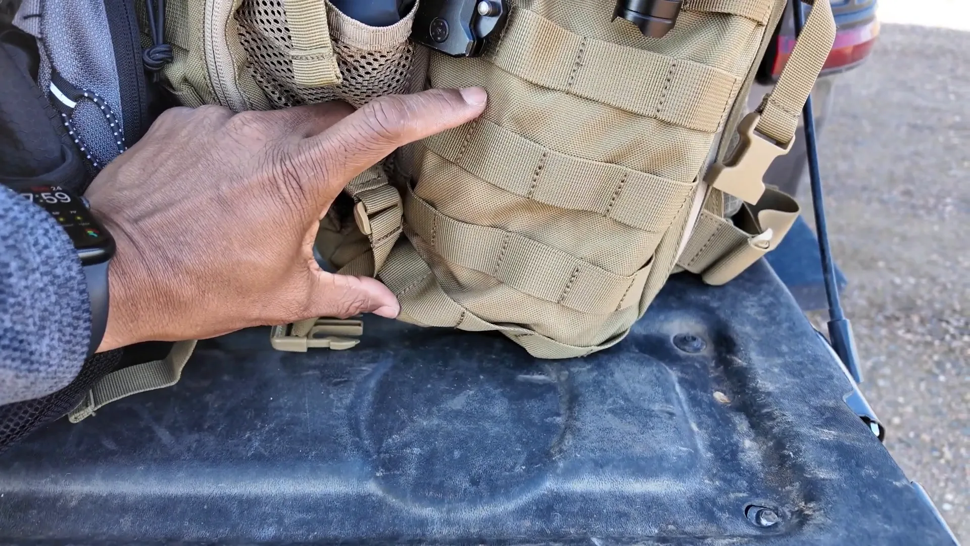 Side webbing that limits easy external pocket use