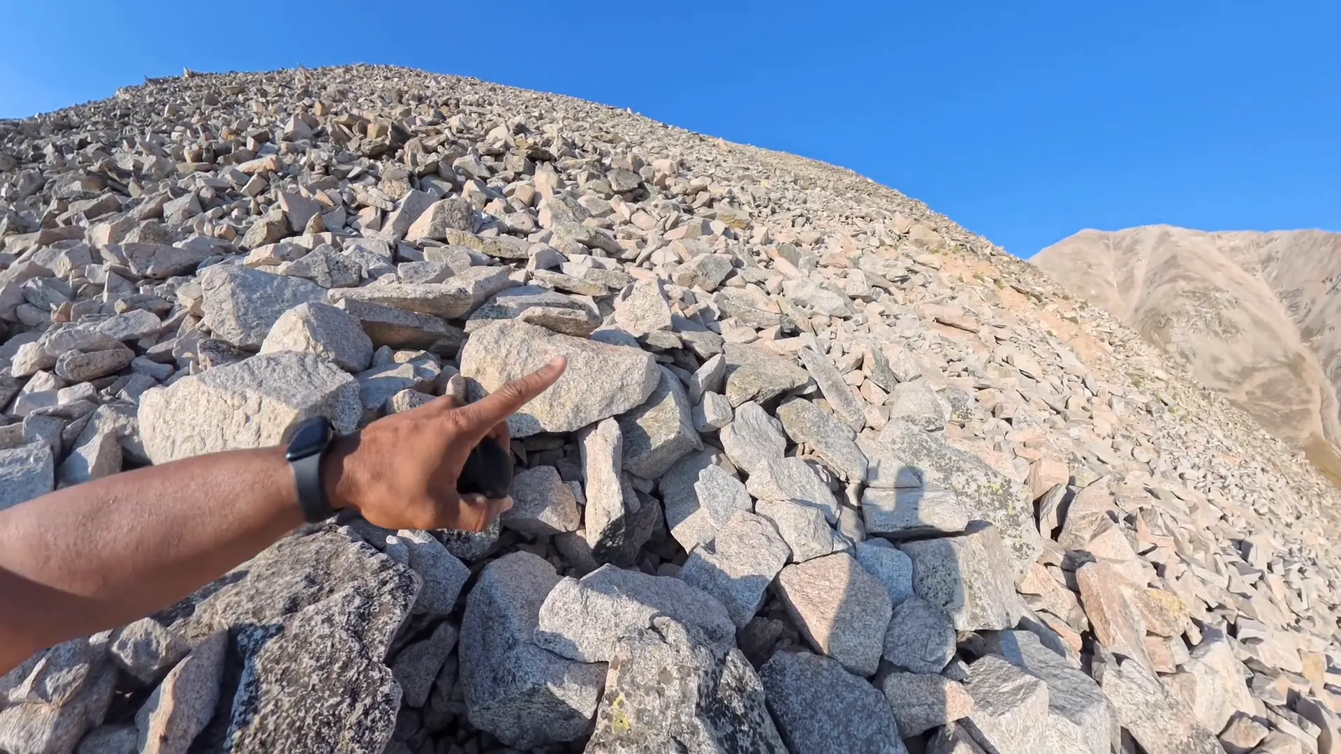 Cairn marker in scree field guiding the route