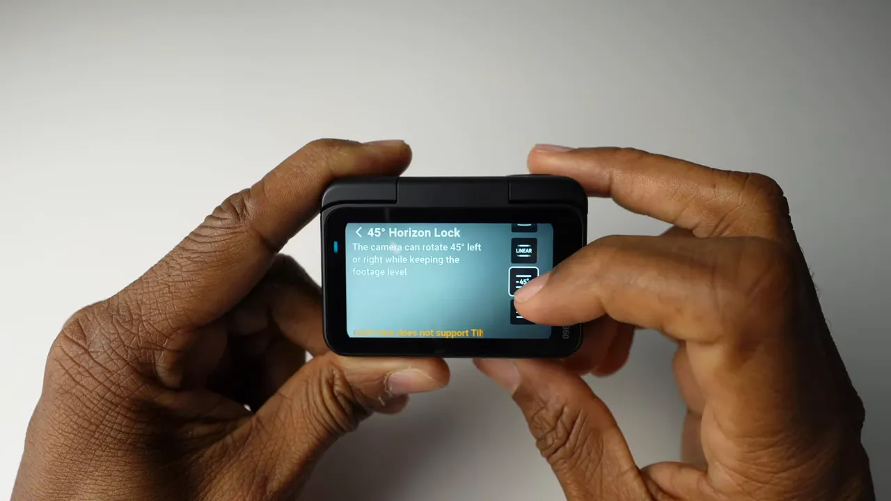 Close-up of insta360 action pod touchscreen displaying '45° Horizon Lock' while a hand interacts with the screen