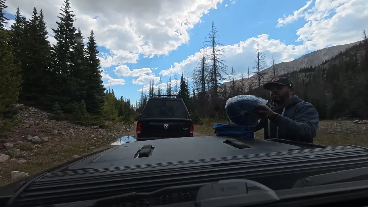 Using a kinetic rope to tow the disabled Jeep down a rocky section of Billing Lake Trail