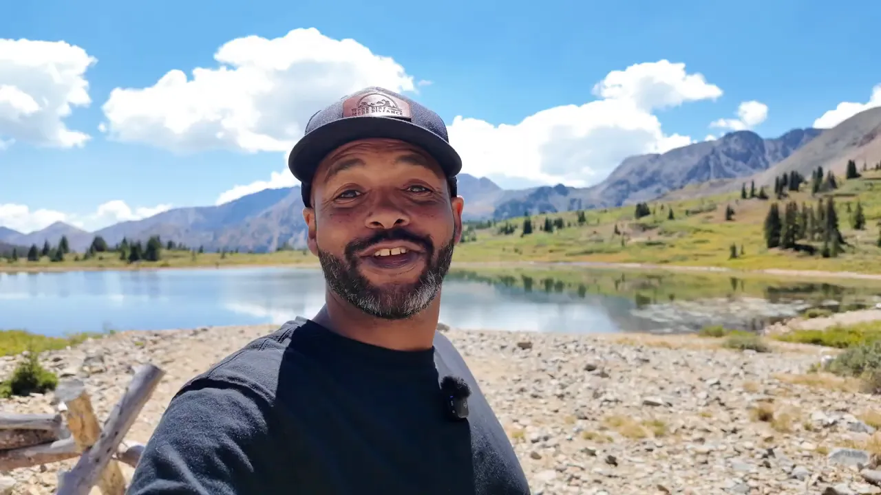 Billings Lake surrounded by mountains with anglers visible near the shore