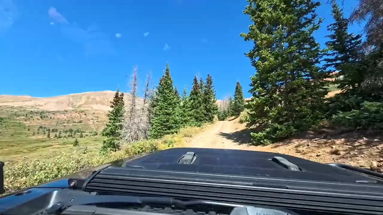 Approach trail toward Pride of the West Tunnel with views opening above the tree line