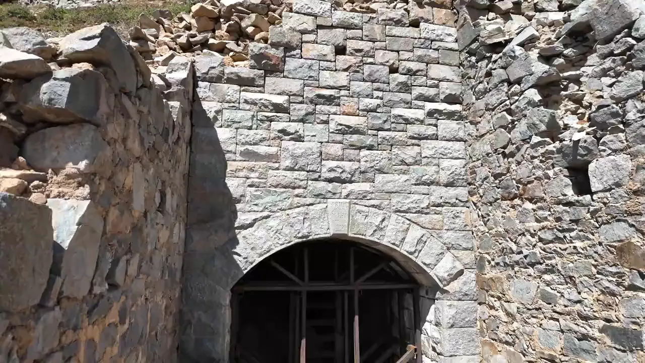 Blocked entrance of the Pride of the West Tunnel with '1880' marker and aged portal