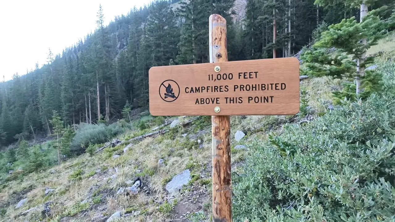 Wooden sign stating 11,000 feet and campfires prohibited above this point