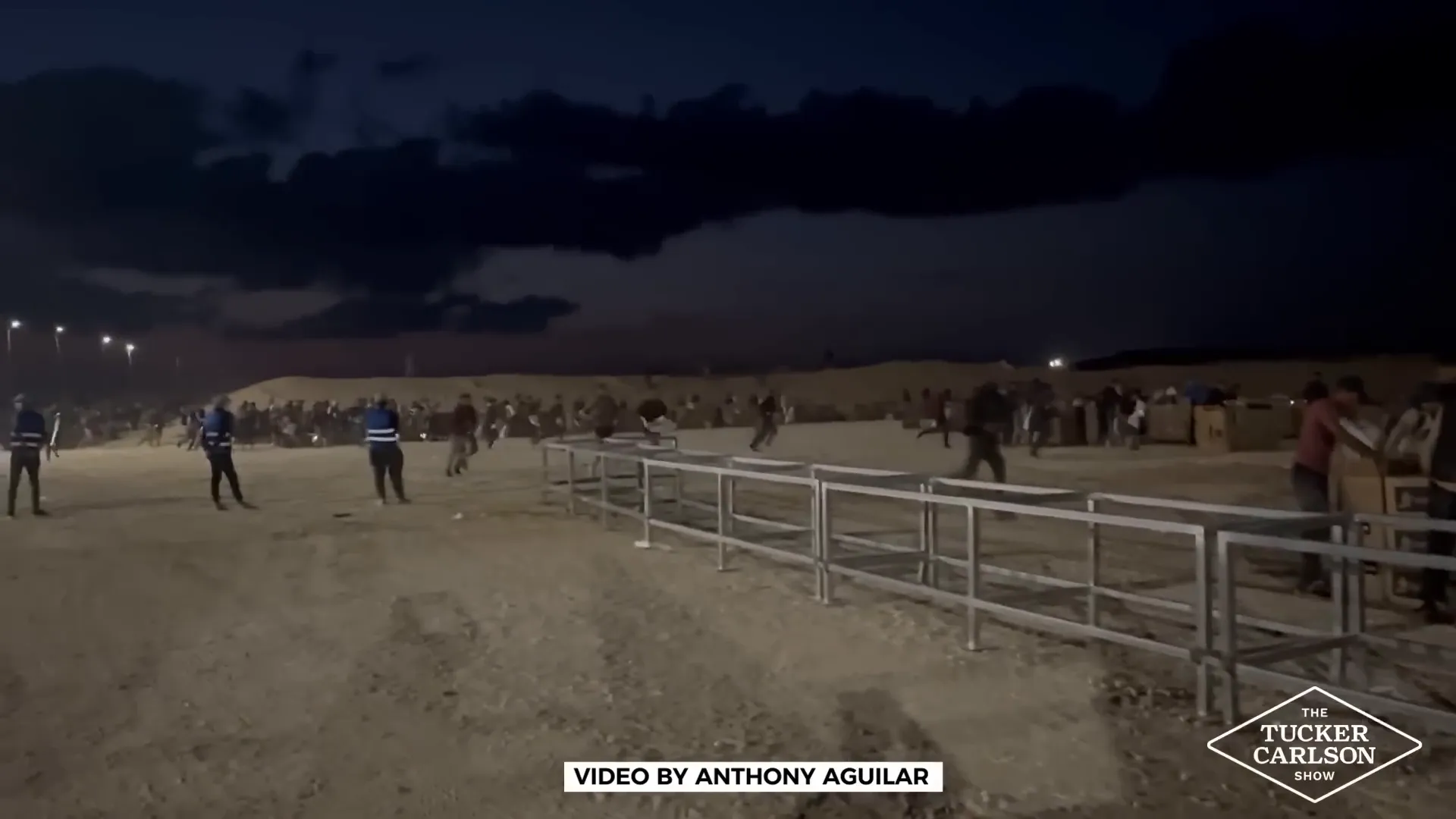 Crowds rushing to aid distribution site under fire