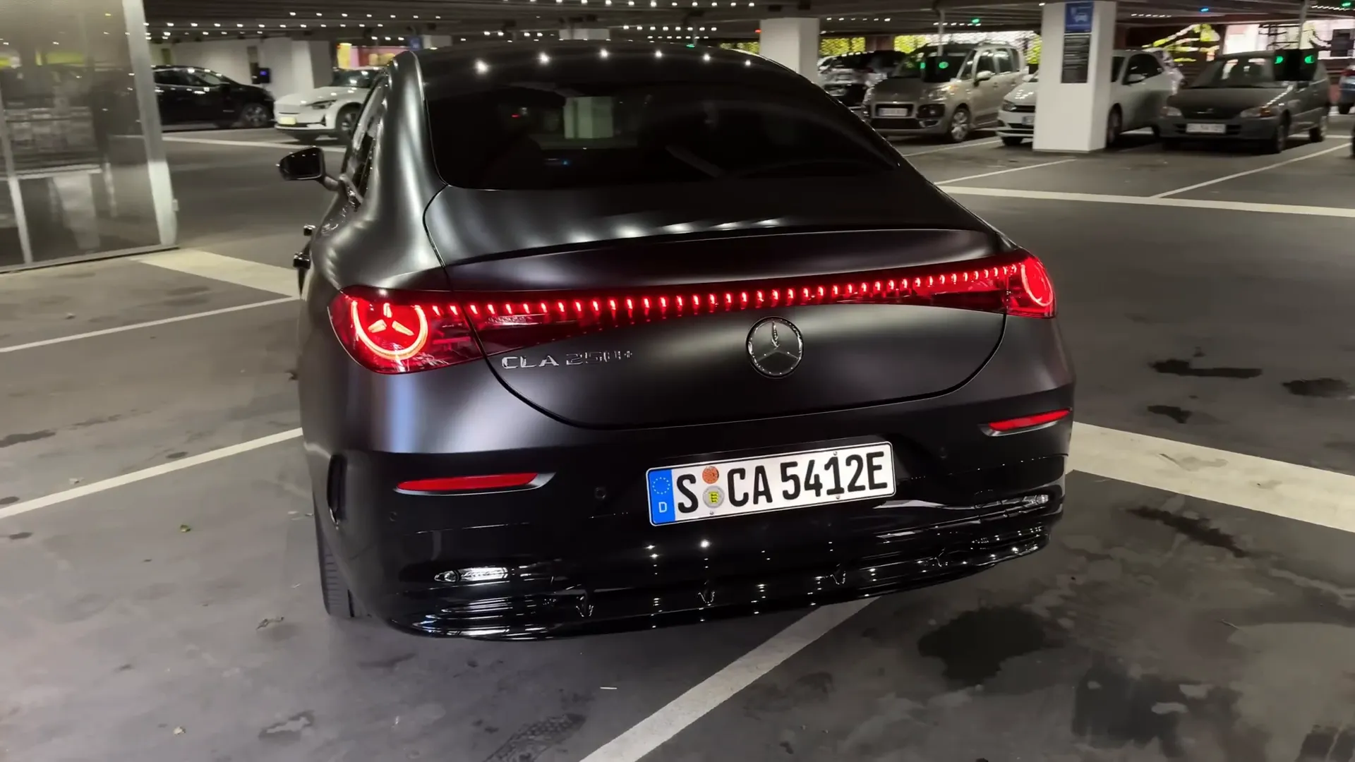 Rear view of the Mercedes CLA with Cosmo Black Magno paint and AMG wheels