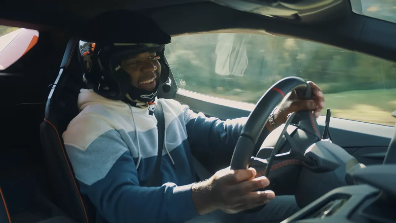 Driver enjoying the car on the track, expressing delight