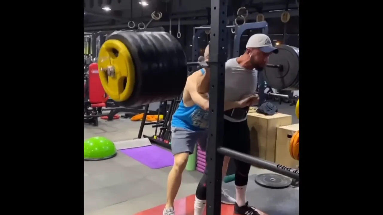 Anatoly hitting a deep squat with heavy weight
