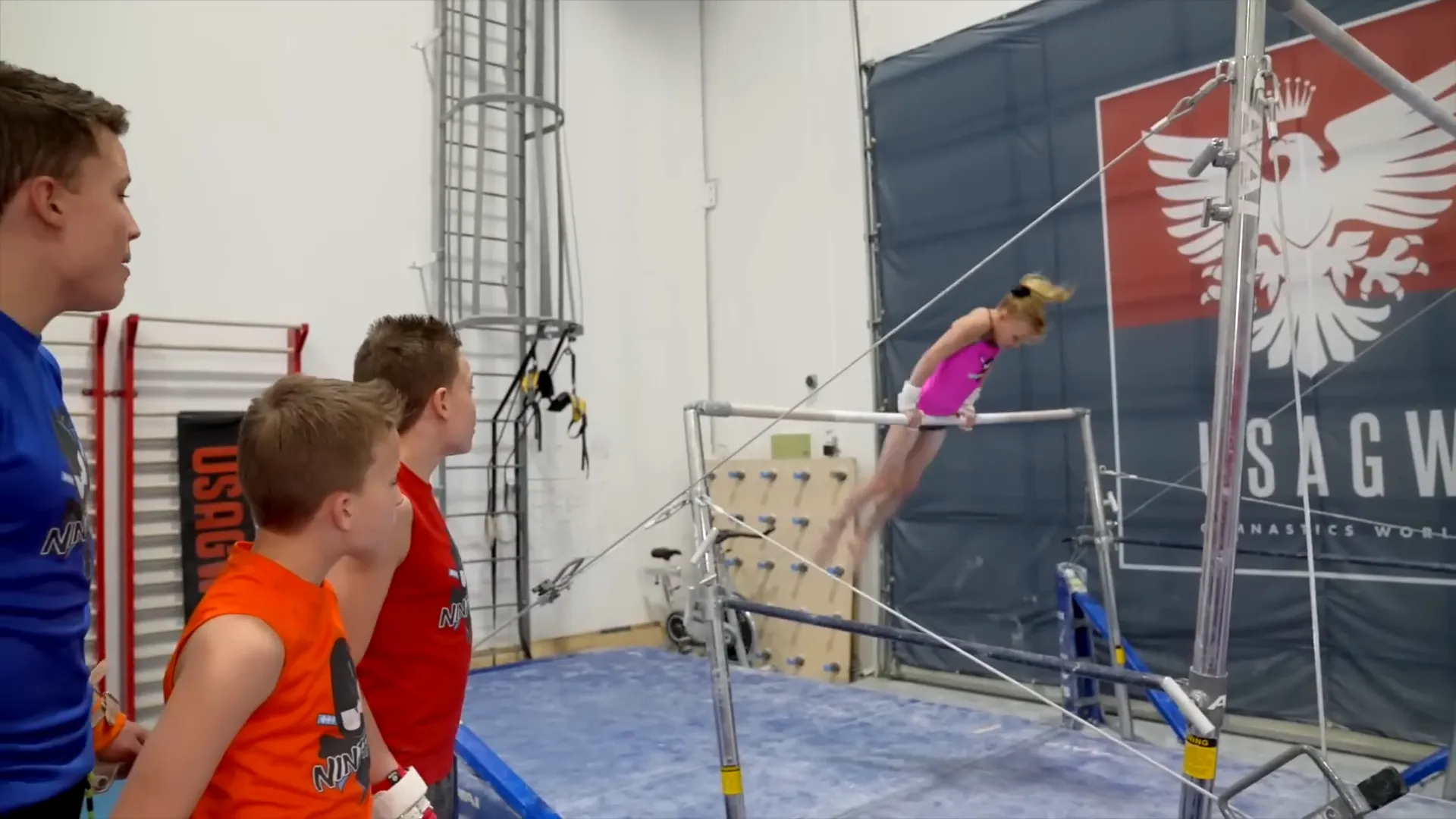 Payton performing kip to handstand on uneven bars