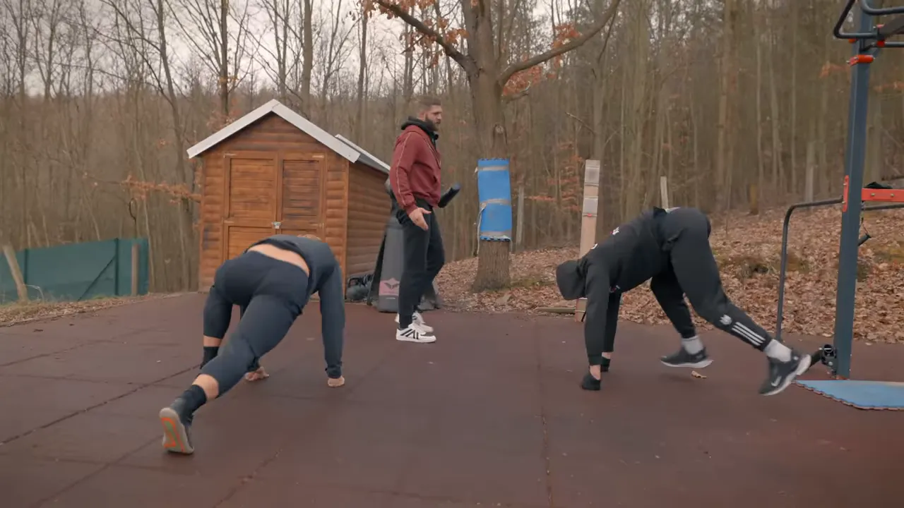 Two training partners moving in sync on the mat practicing distance, rhythm, and counters with a coach in the middle