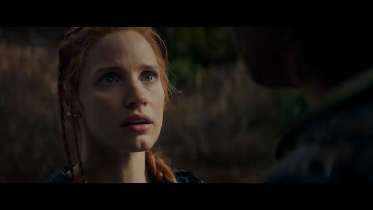 Close-up of a red-haired heroine looking upward with an expressive, thoughtful face in forest light