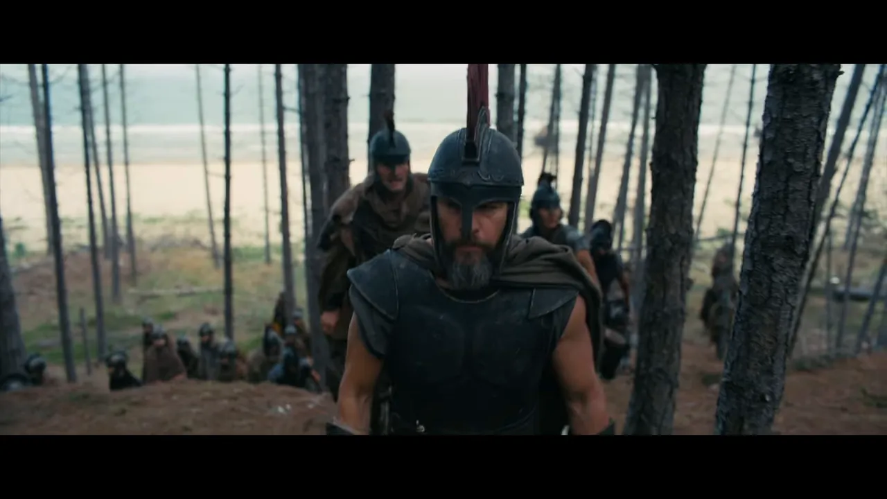 armored commander leading soldiers through coastal pine woods