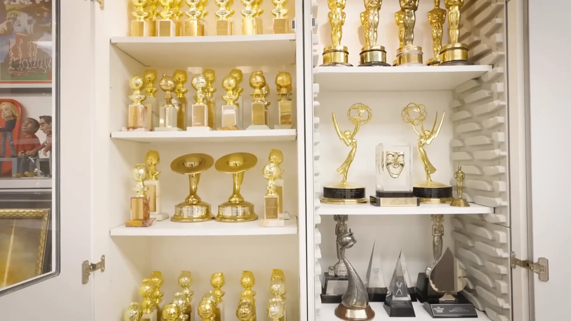 Awards case showcasing Oscars and Emmys