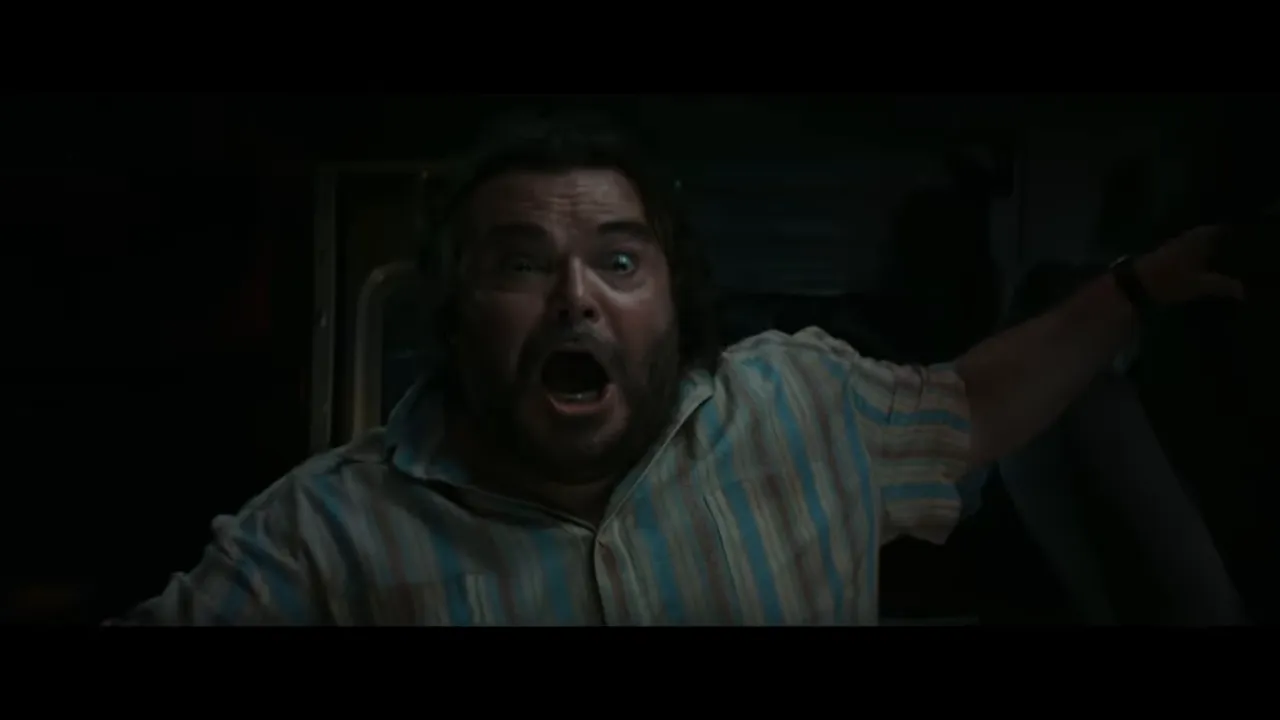 Lead actor screaming in panic inside a dark vehicle