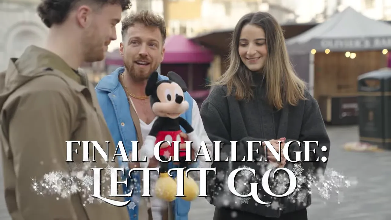 Host holding Mickey plush with two contestants and 'Final Challenge: Let It Go' title graphic onscreen