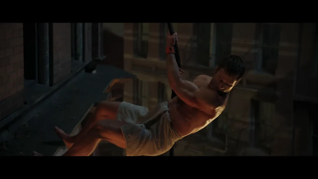 Towel-clad figure descending along a building facade holding a rope, mid-motion.