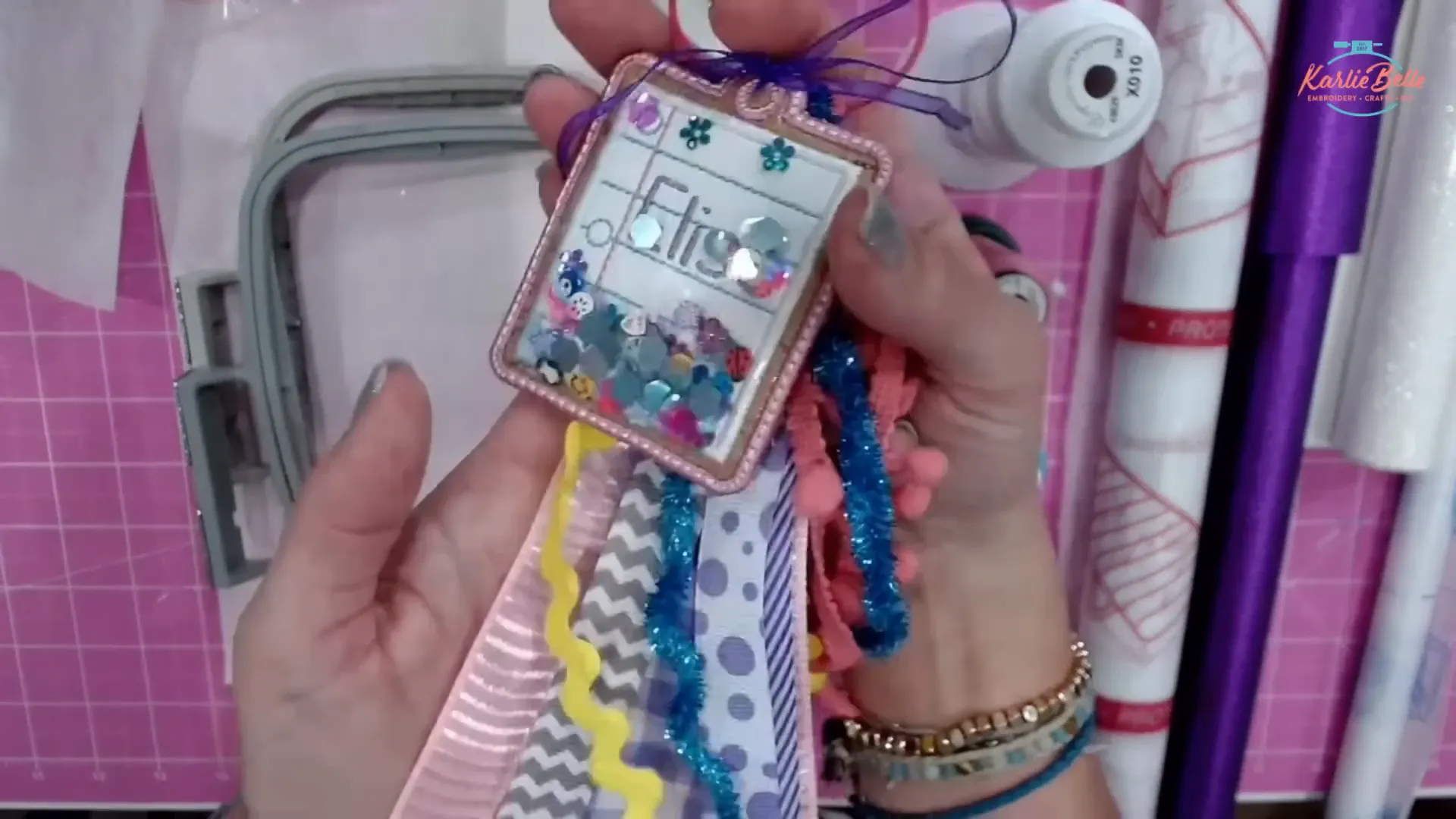 Finished blue ribbon shaker bag tag on craft table