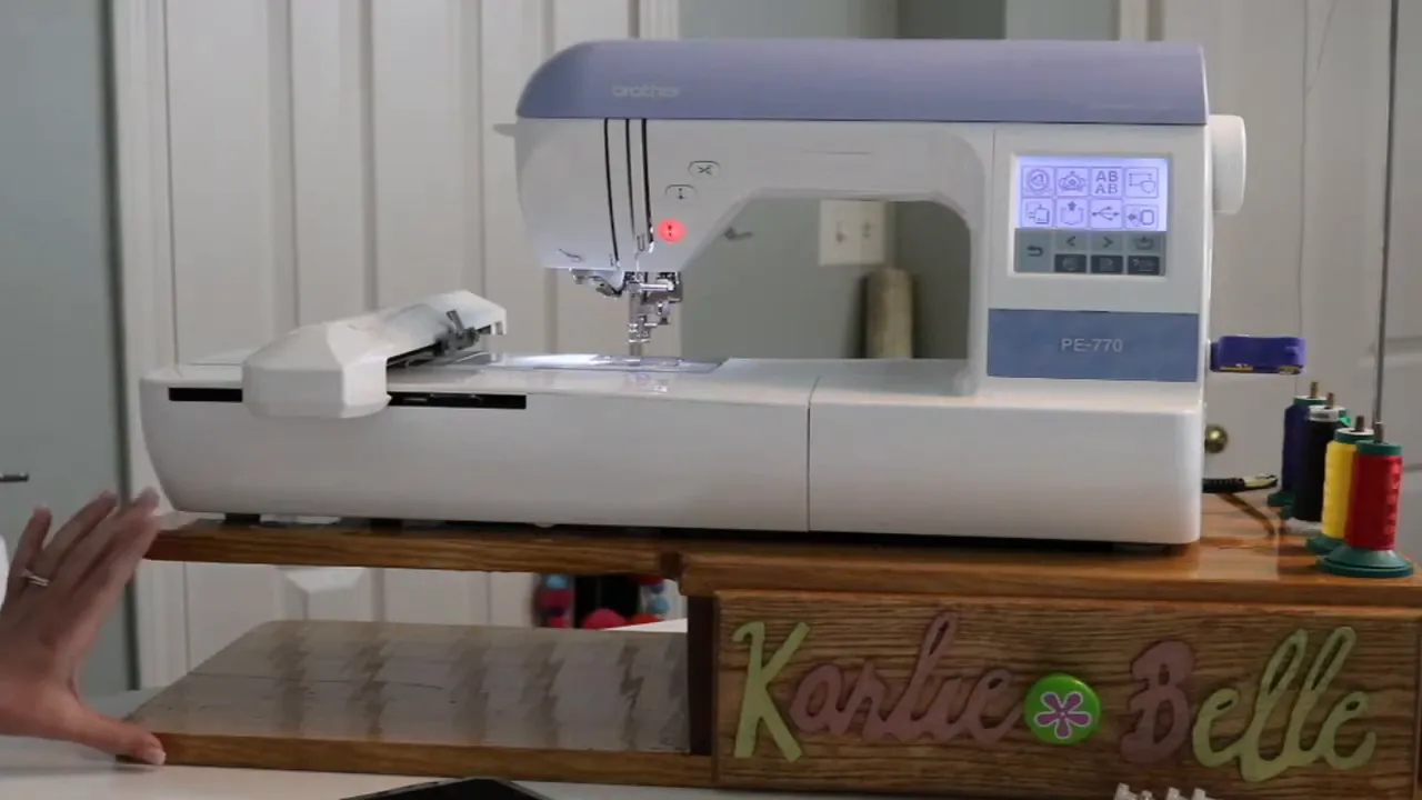 White embroidery machine resting on a wooden riser above the table