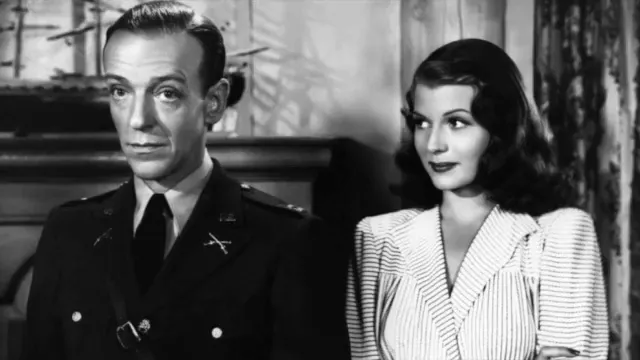 Black-and-white two-shot of the film's lead actors standing side-by-side in costume, composed to emphasize their partnership.