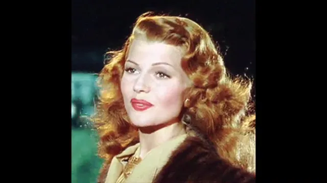 Color close-up portrait of the film's leading actress with styled red hair and a fur-collared coat.