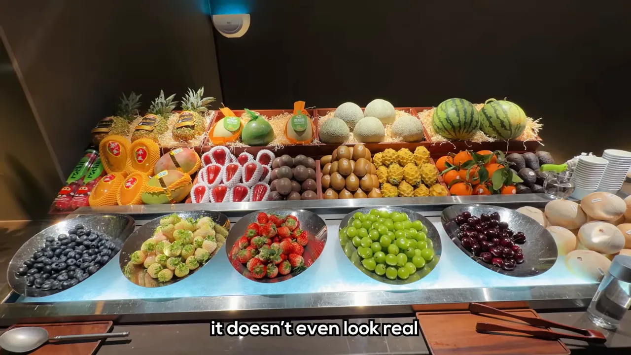 Chilled fruit bar with plates of cut fruit arranged in rows