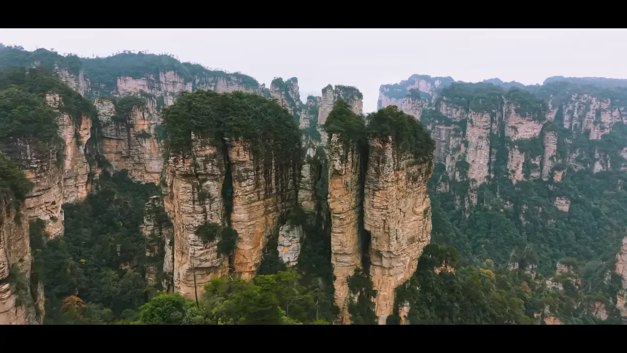 Panoramic view of tall sandstone pillars covered with greenery