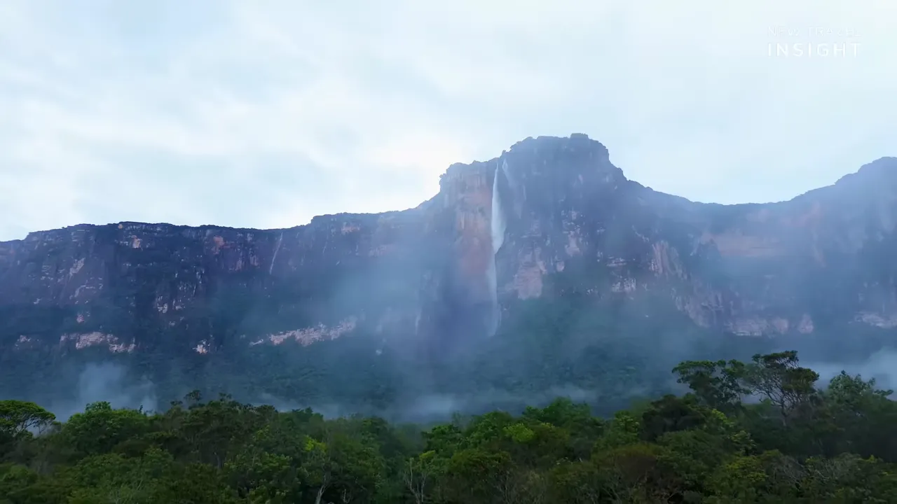 Wide shot of Angel Falls and surrounding rainforest cliffs with mist in Venezuela