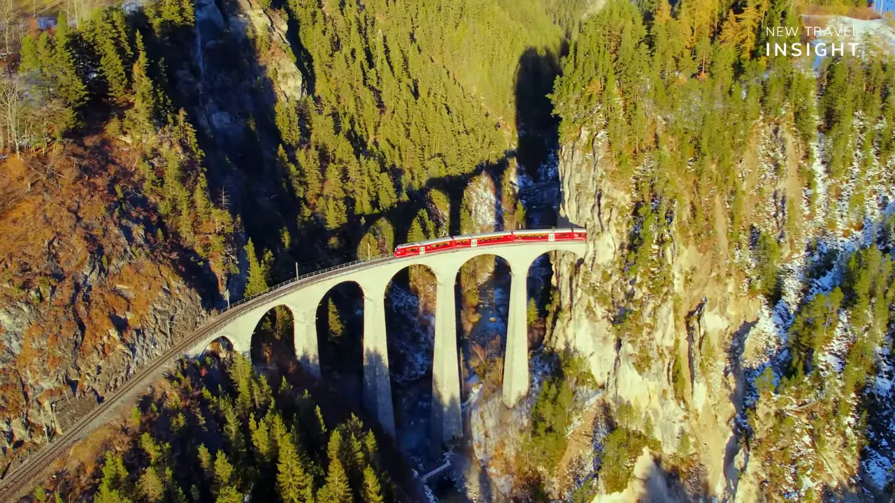 Landwasser Viaduct stone arches with a red train in an alpine valley, Switzerland