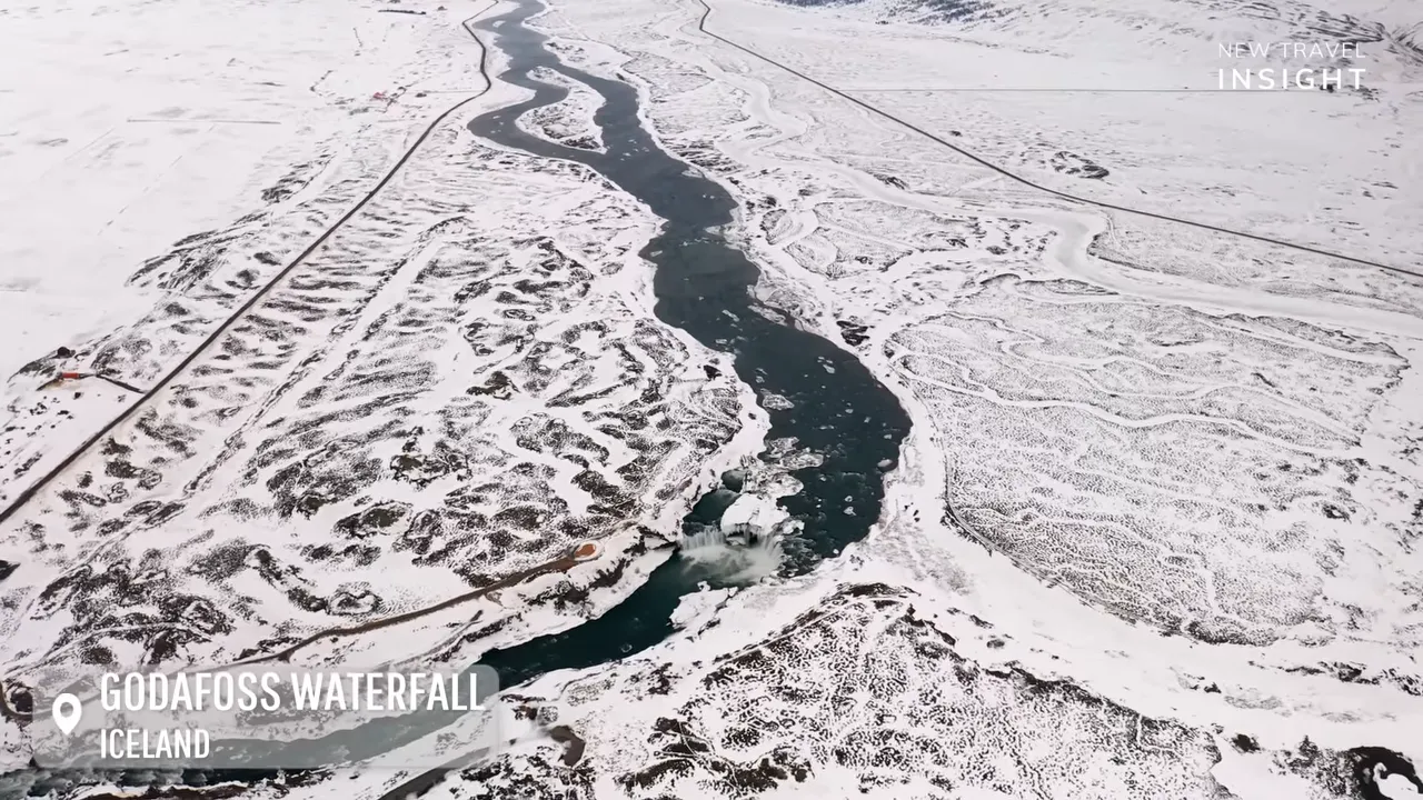 Aerial view of the Godafoss area in Iceland with snow-covered terrain and a winding river valley
