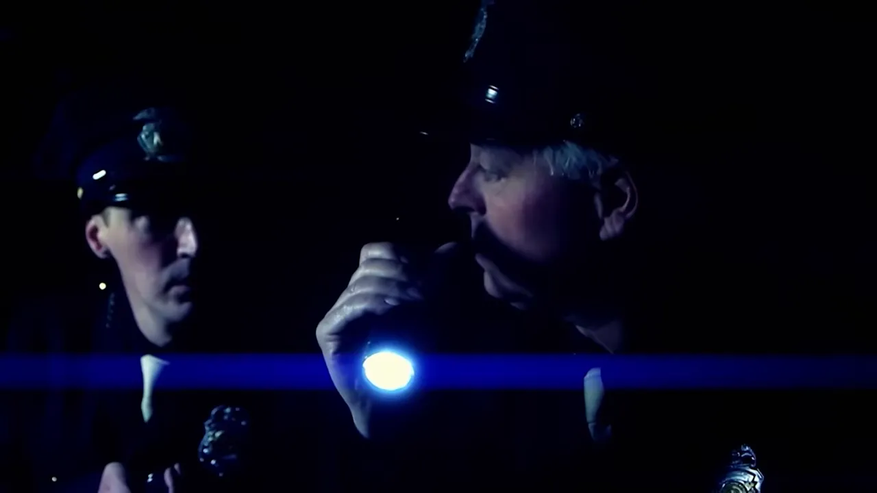 Investigators pulling a face-mask from a receptacle during the search