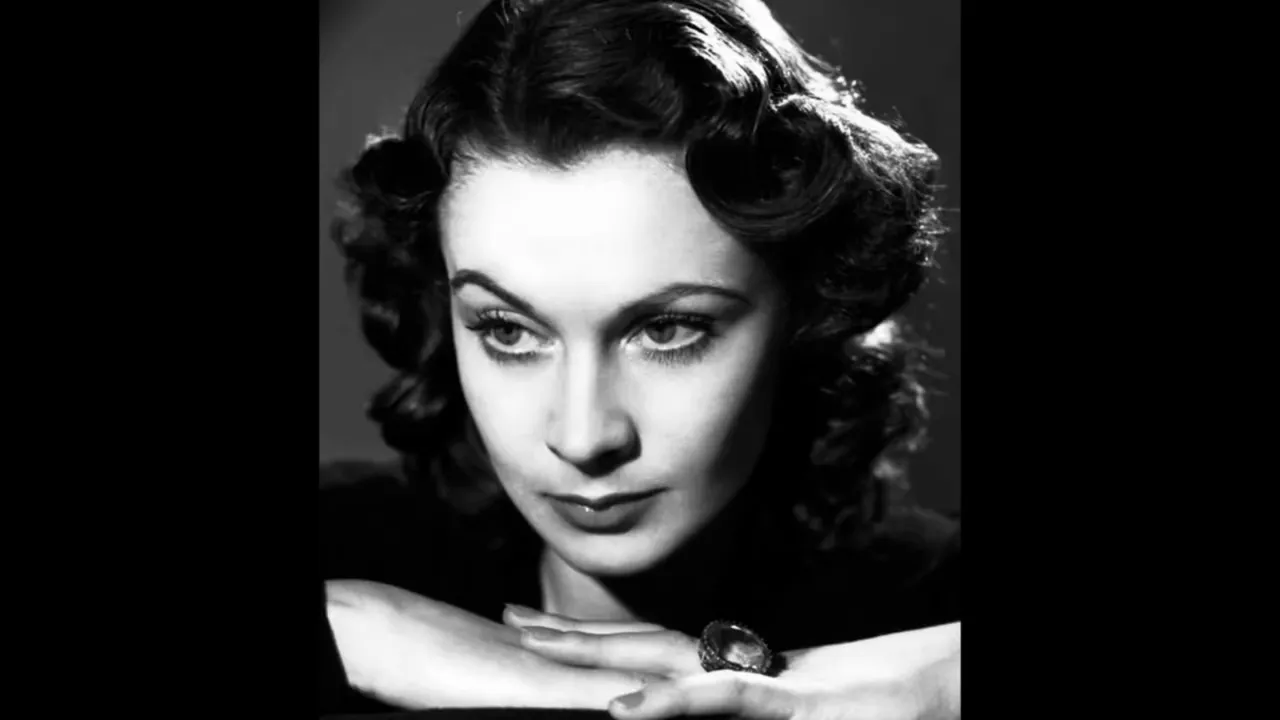 High-contrast black-and-white portrait of a woman looking slightly downward