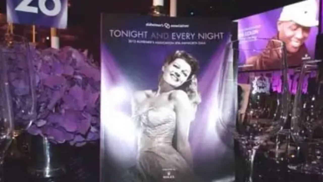 Purple gala display with a large Rita Hayworth portrait and event signage