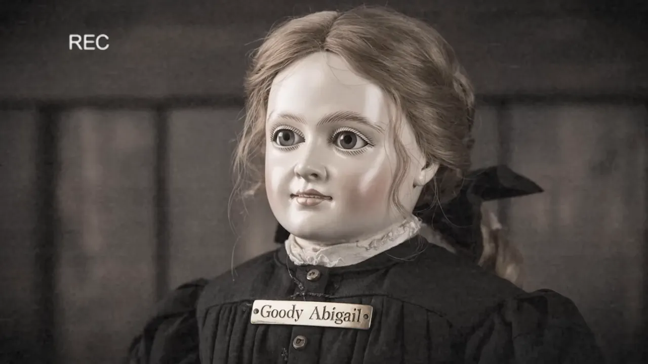 Goody Abigail, a carved wooden doll wearing a black Puritan dress, discovered in an old house