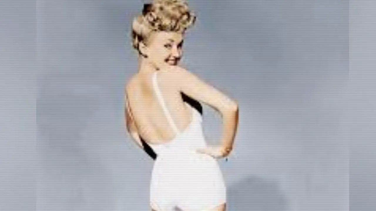 Betty Grable smiling over her shoulder in the famous white swimsuit photo
