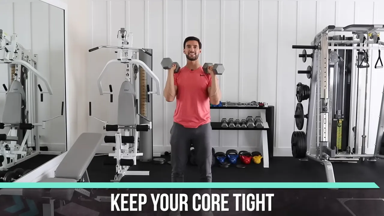 Trainer standing with dumbbells at shoulder height and text reading keep your core tight