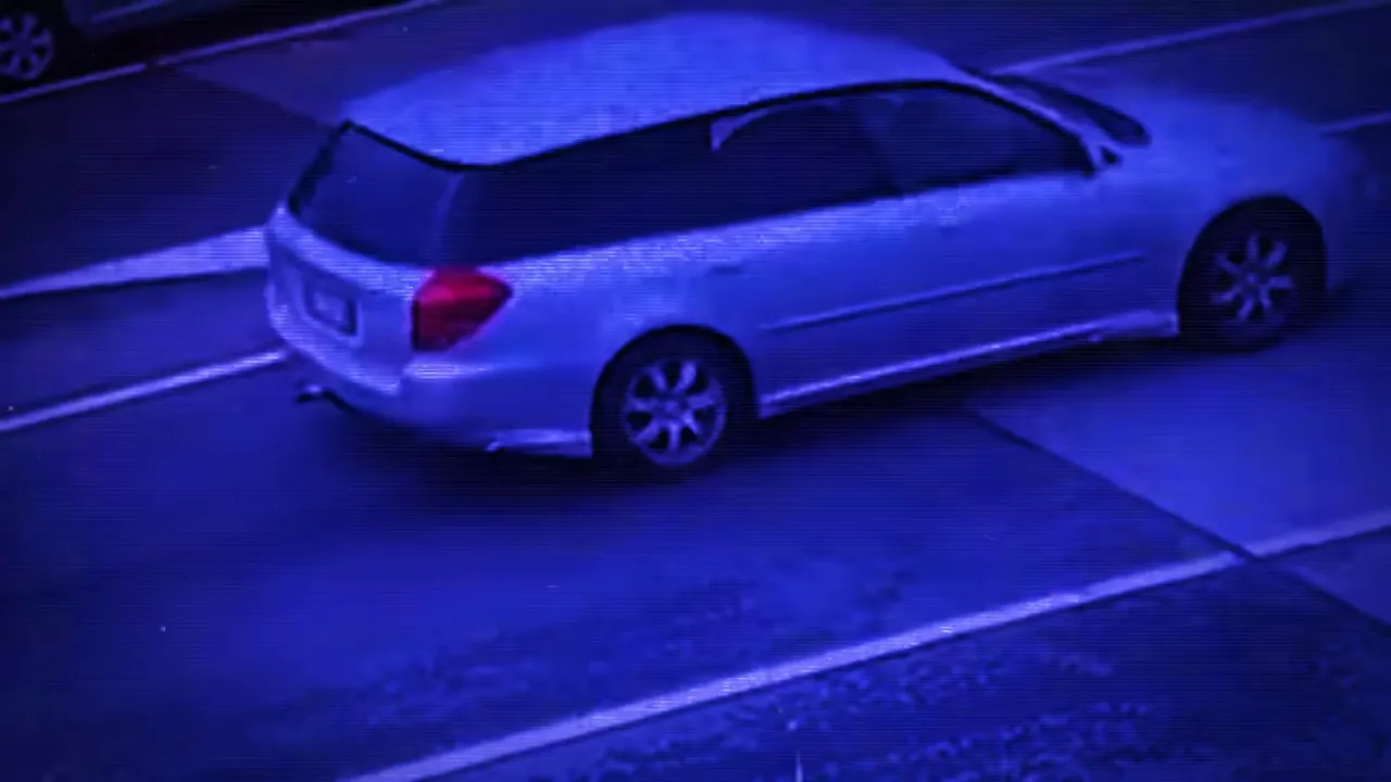 Car driving away from the scene as ambulances arrive