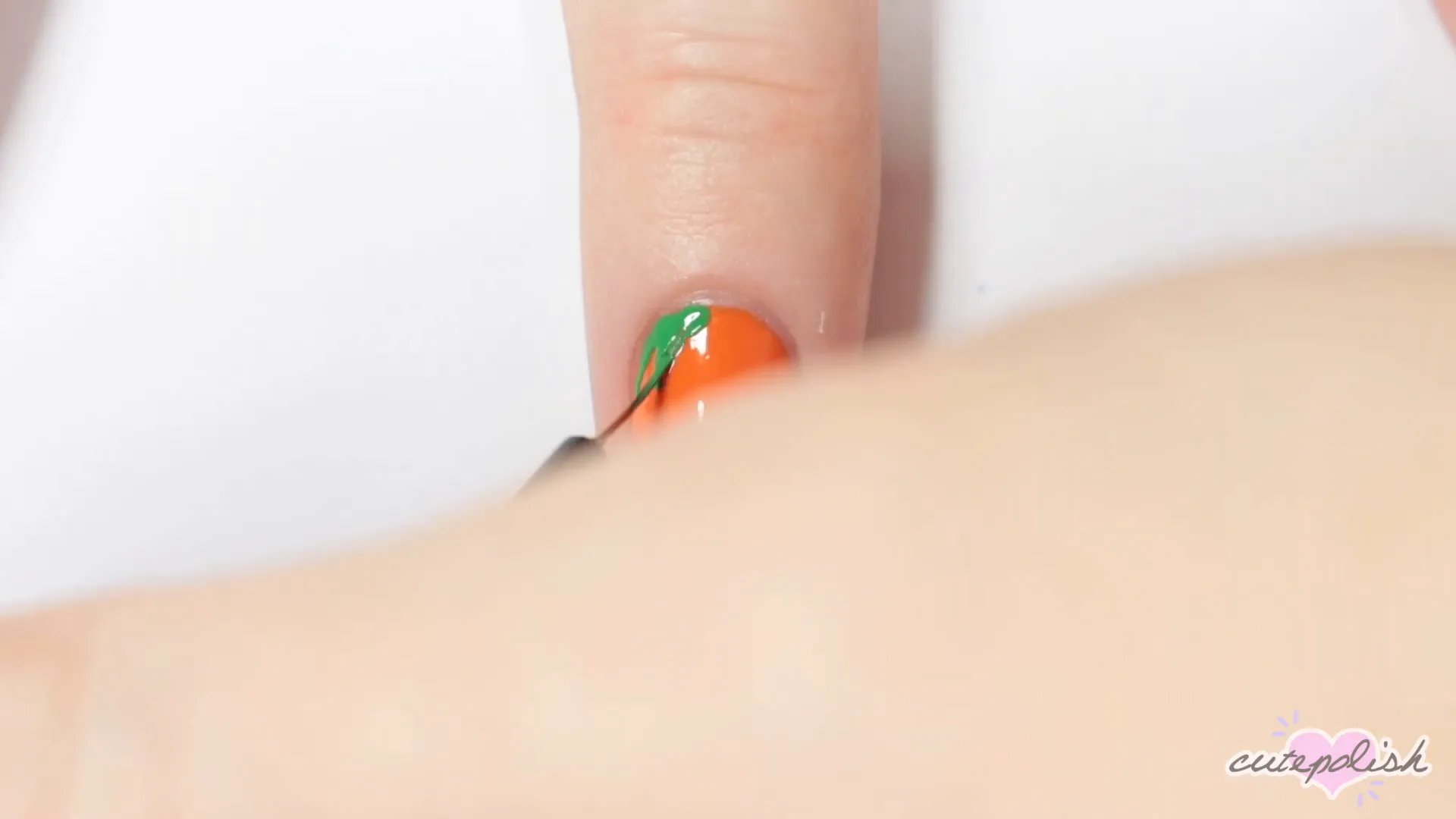 Creating the top of the jack-o'-lantern with green polish.