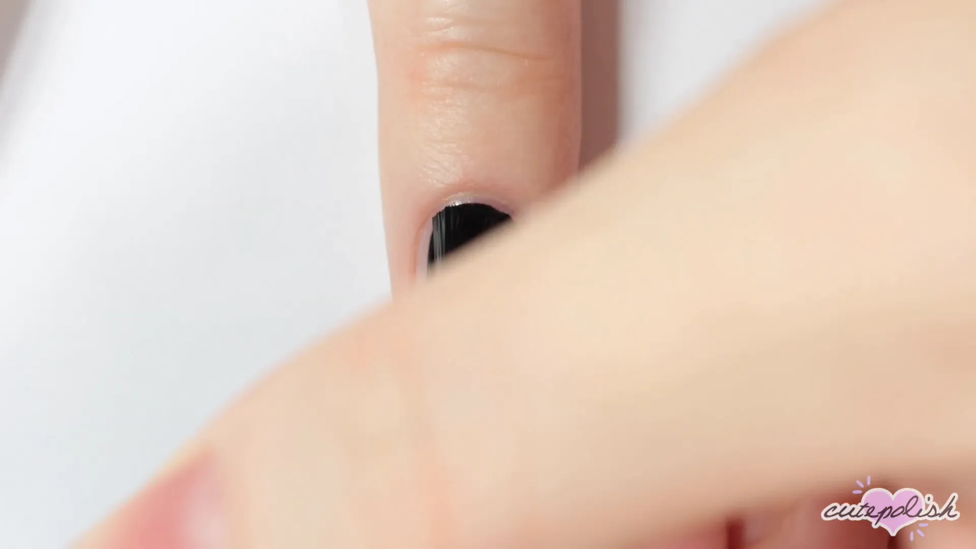 Creating spider web lines on a black nail.