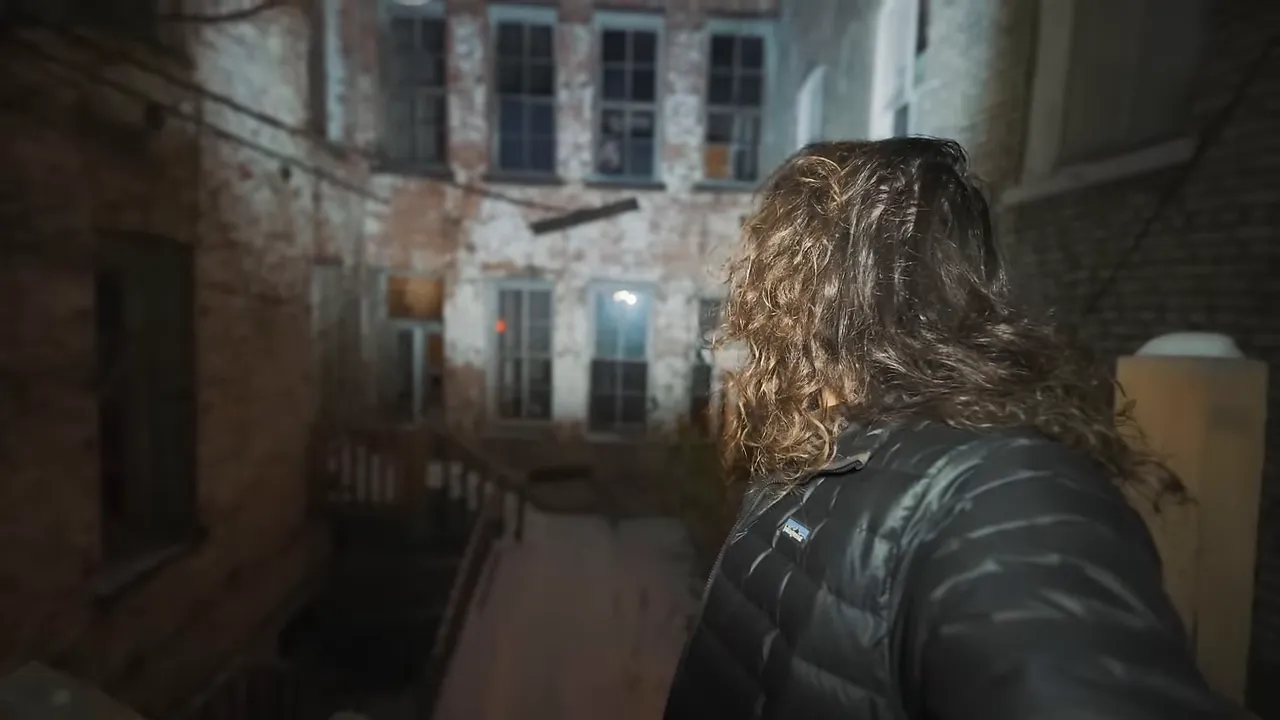 Back door of the Washoe Club with cracked entry and snow-covered steps leading down