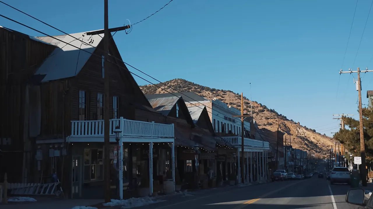 Street view of Virginia City with historic wooden buildings and empty sidewalks