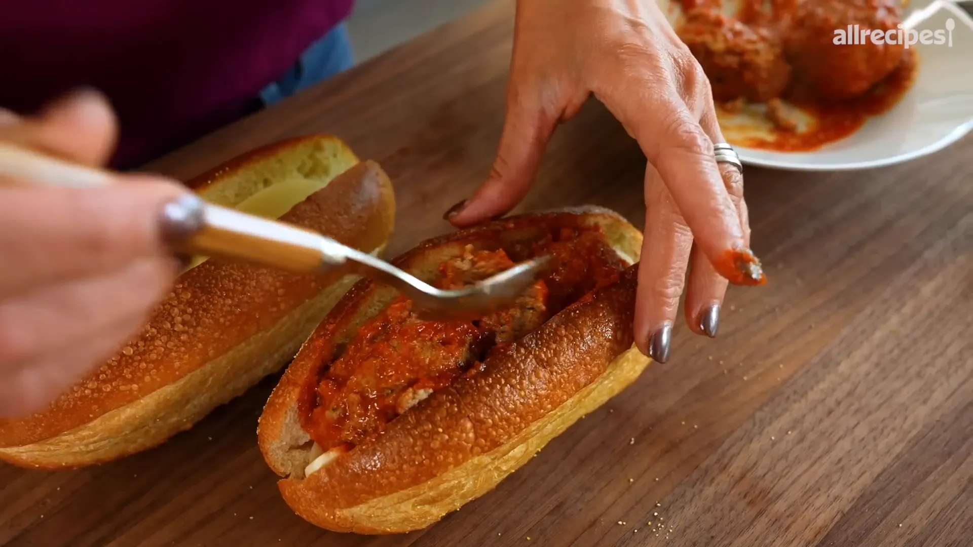 Building the ultimate meatball sub with cheese and sauce