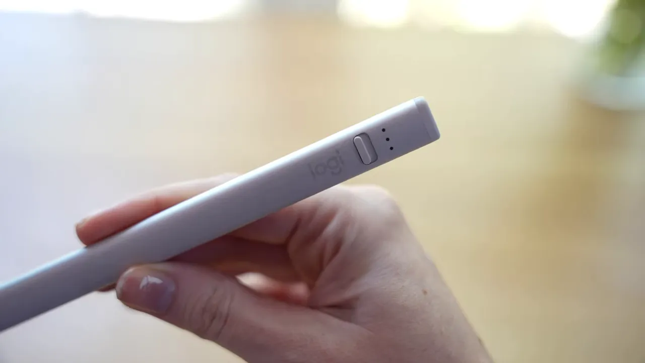 Angled close-up of the Logitech Crayon stylus held in a hand
