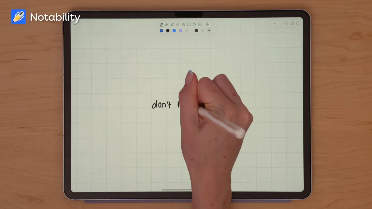 Noteful handwriting sample being written on grid paper with Apple Pencil