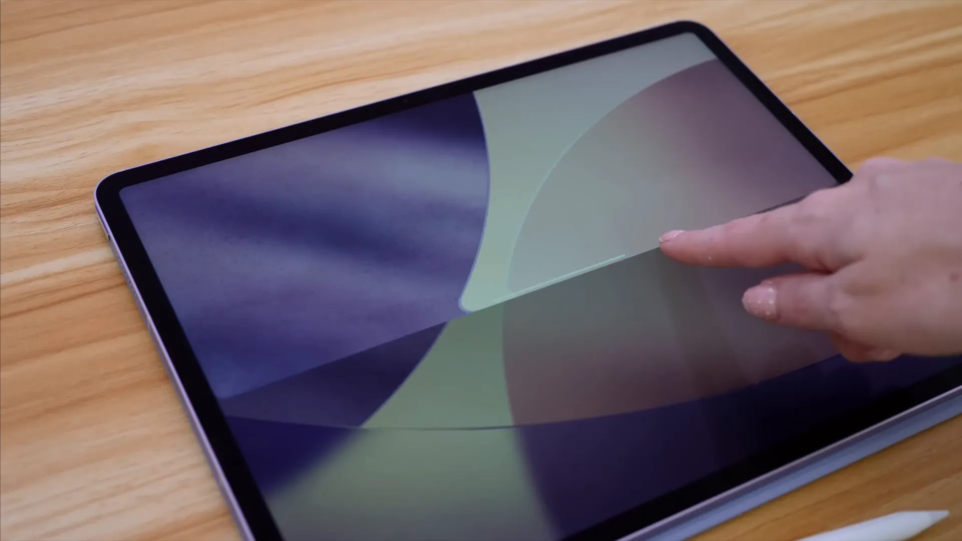 Lock screen showcasing Liquid Glass design and rounded visuals