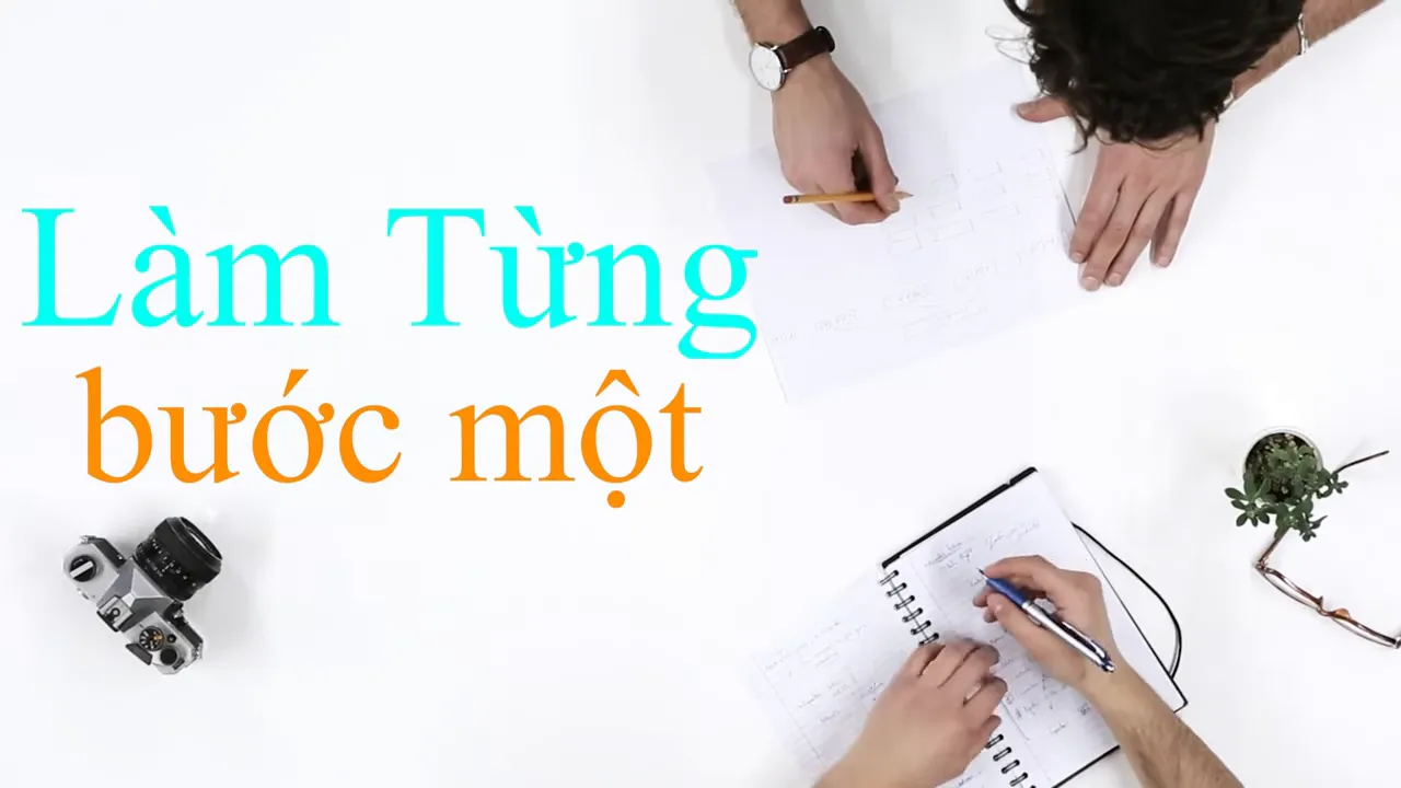 Bàn làm việc nhìn từ trên xuống với dòng chữ Làm từng bước một
