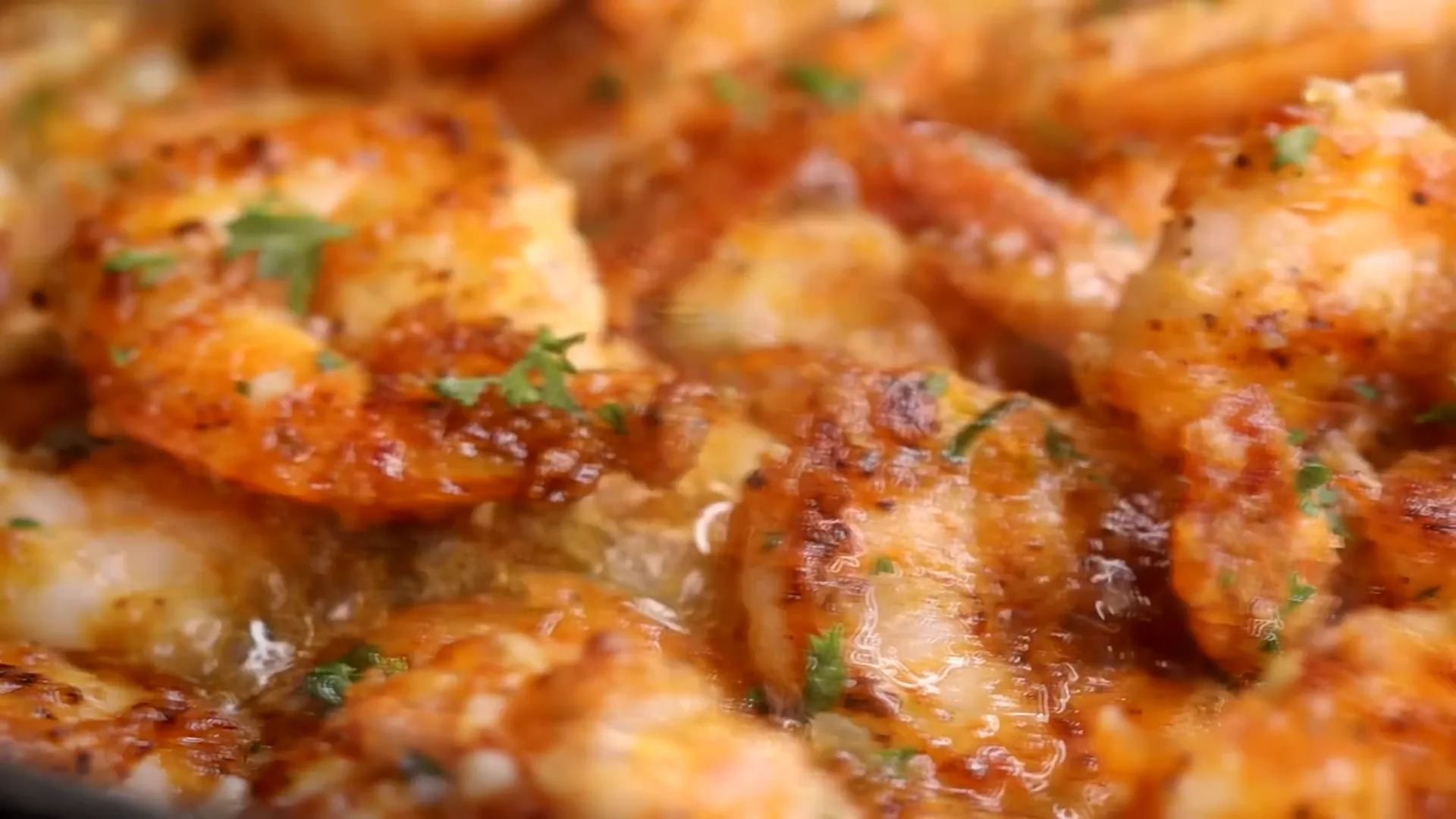 Garnishing garlic butter shrimp with parsley