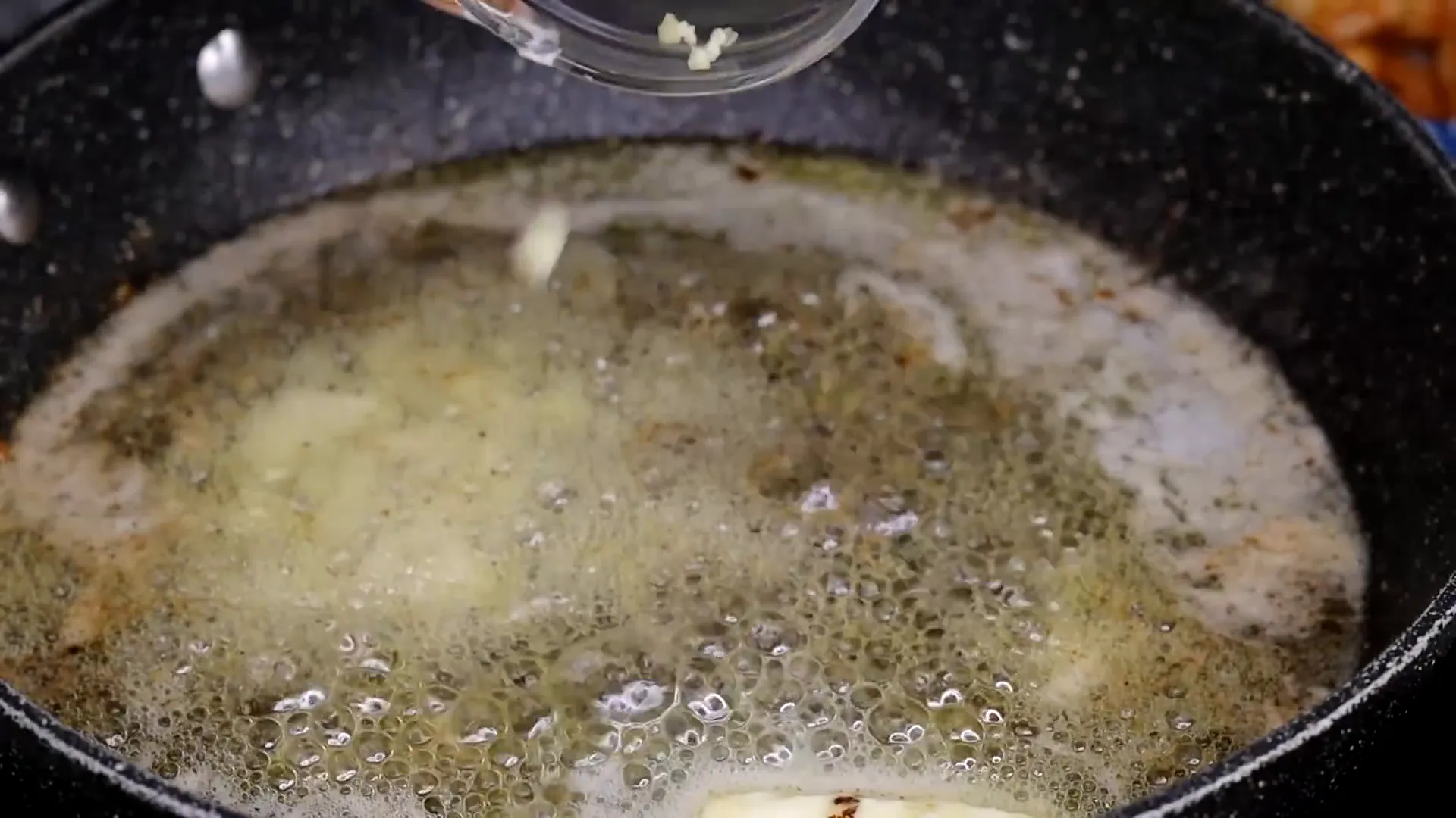 Adding garlic and parsley to the skillet