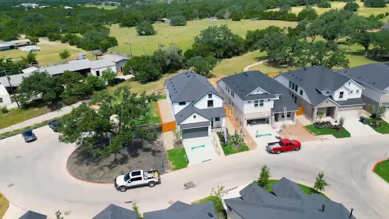 Aerial street view of new single-family homes and yards in a Leander neighborhood