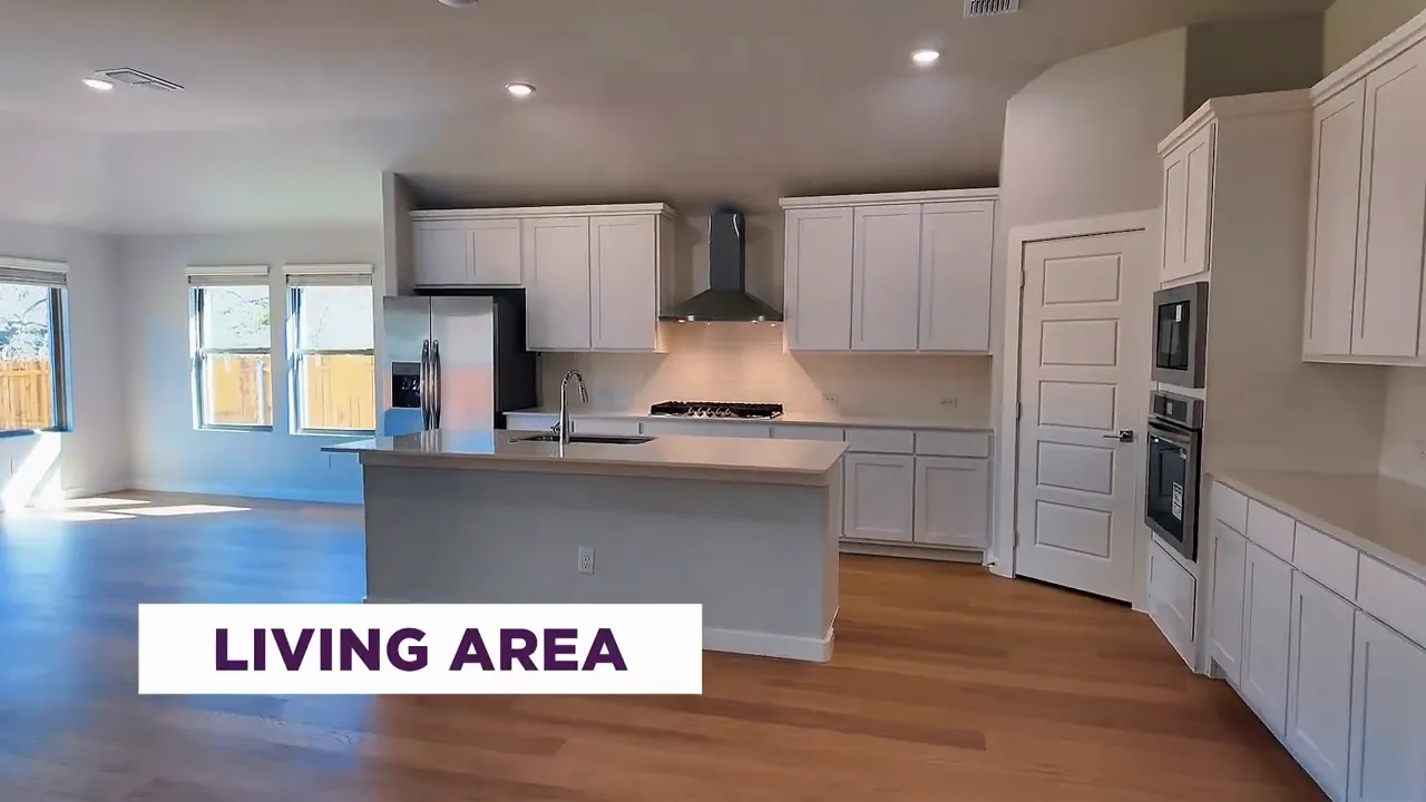 Princeton Texas new construction kitchen and living area with gas cooktop and white cabinetry