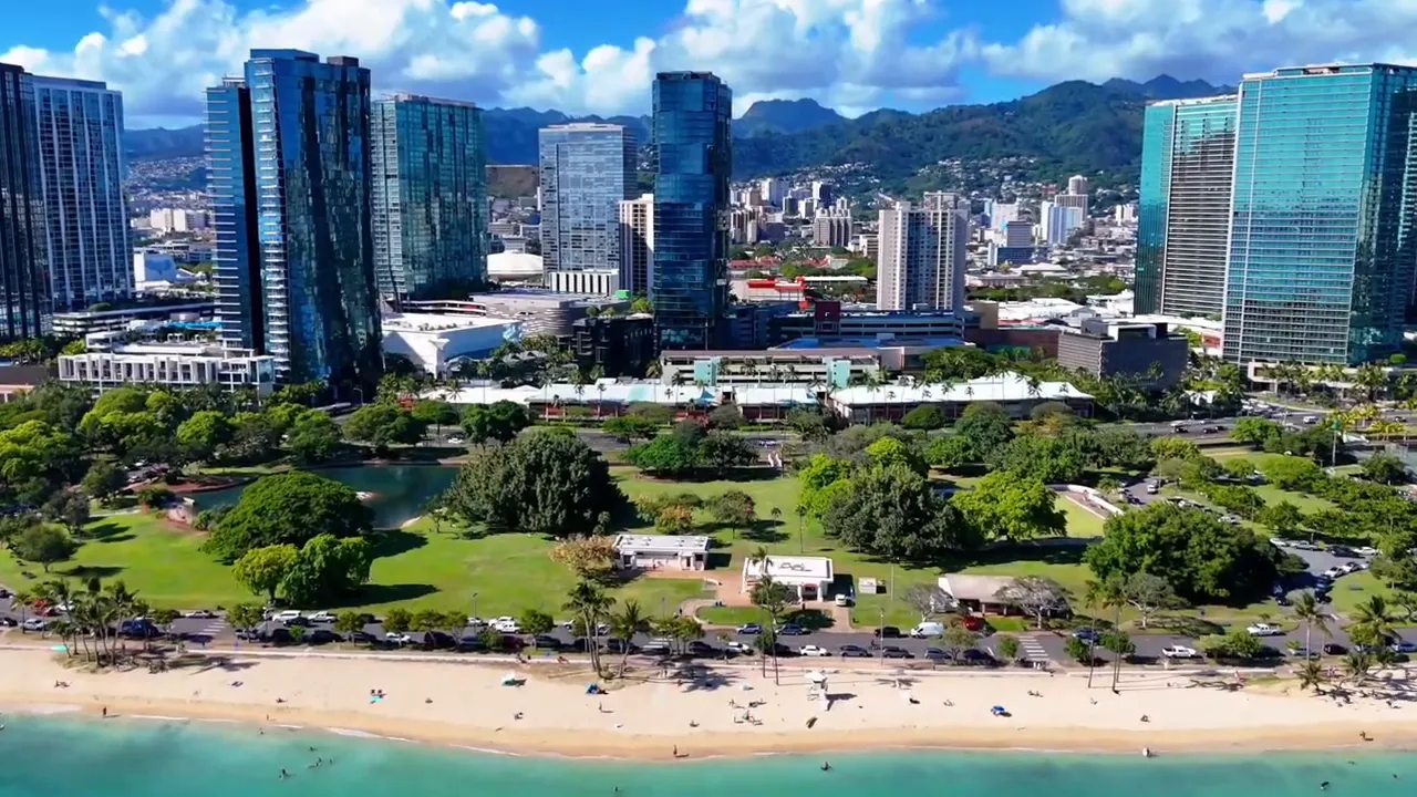 Aerial view of Honolulu buildings, beach, and coastline illustrating Hawaii rental investment setting